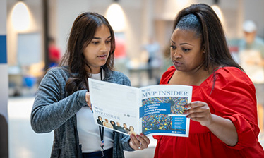women reading brochure
