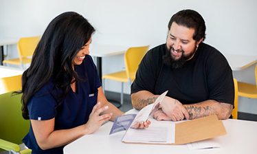 woman and man reading brochure