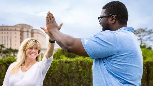 High five between two people